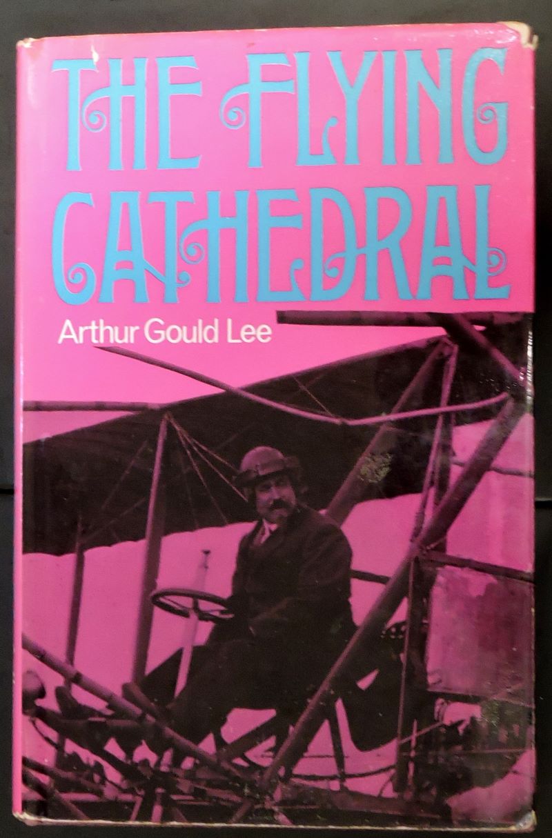 Picture of book's pictorial cover showing man sitting at the controls of a primitive aeroplane